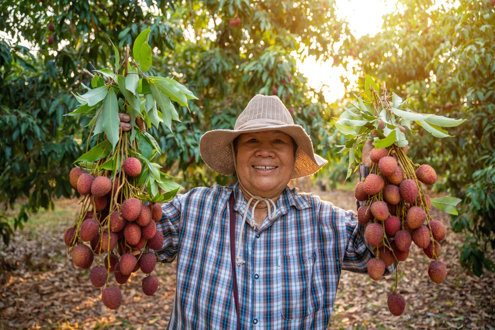A smiling farmer showing her harvest